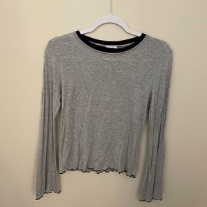 Grey long sleeve top with lettuce edge hem